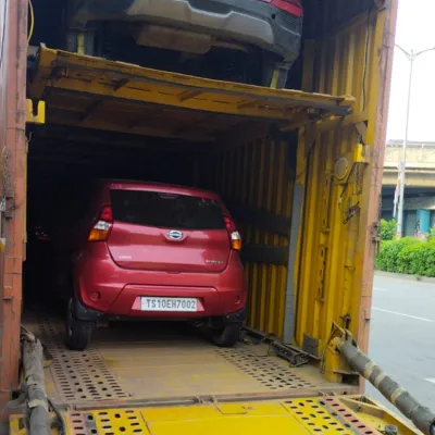 Car being loaded onto transport carrier